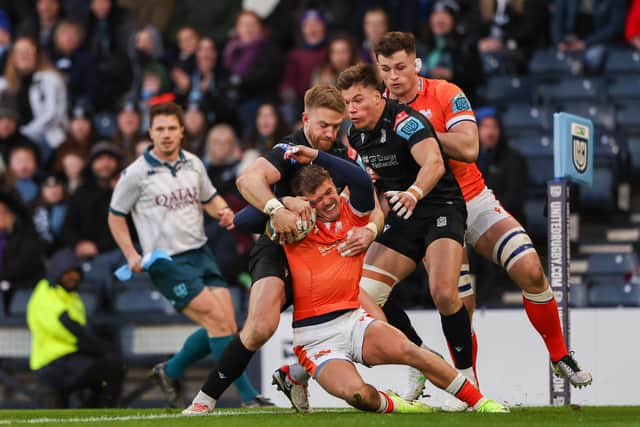 Edinburgh's Darcy Graham is tackled by Glasgow Warriors' Kyle Steyn and Huw Jones during the 1872 Cup first leg at Hampden.