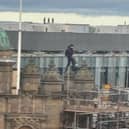 Men were spotted on the roof of Jenners on Christmas Eve