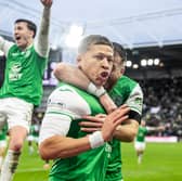 Dwight Gayle is embraced by Nicky Cadden as Josh Campbell leaps for joy; Gayle has just scored the winner at Tynecastle. 