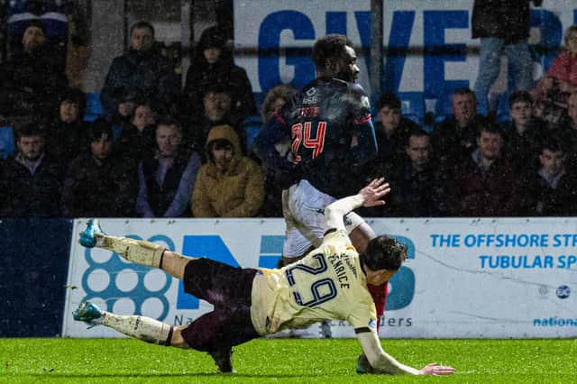 Ross County's Michee Efete fouled Hearts' James Penrice but after initially awarding a penalty referee Ross Hardie changed his decision to a free-kick after consulting VAR.