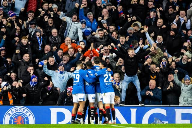 The Rangers players celebrate in front of their fans.