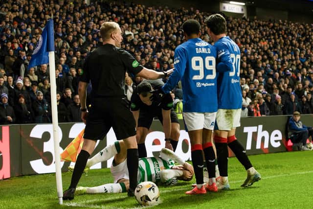 Celtic's Arne Engels falls to the ground after being struck by a coin thrown by a Rangers fan at Ibrox.  (Photo by Alan Harvey / SNS Group)