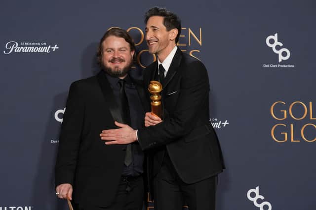 Brady Corbet, winner of the award for best director - motion picture for "The Brutalist", left, Adrien Brody, winner of the award for best performance by a male actor in a motion picture - drama for "The Brutalist", pose in the press room during the 82nd Golden Globes on Sunday, Jan. 5, 2025, at the Beverly Hilton in Beverly Hills, Calif. (AP Photo/Chris Pizzello)
