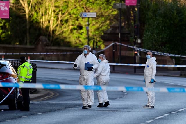 Forensics officers on the scene in Glasgow. Picture: John Devlin