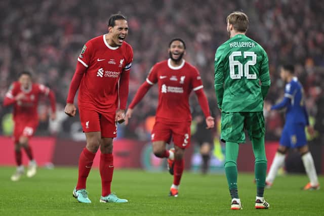 Former Celtic defender Virgil van Dijk celebrates with Caoimhin Kelleher of Liverpool.