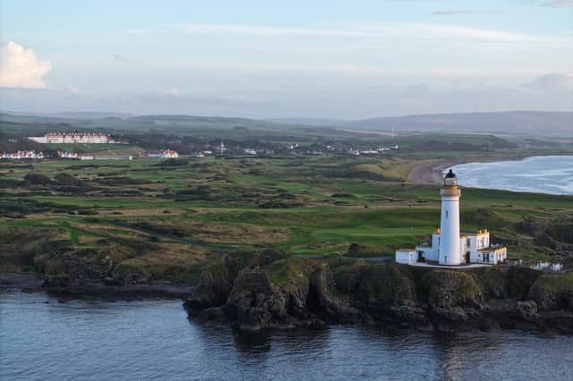 Trump Turnberry with the remains of Turnberry Castle on the promontory in the foreground, to the left of the lighthouse.