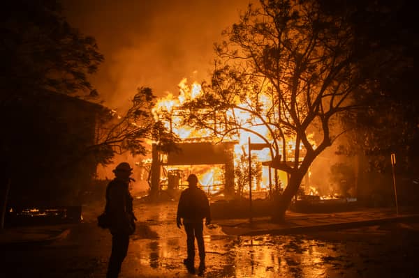 A wildfire engulfs a home in the Pacific Palisades area of Los Angeles earlier this week (Picture: Apu Gomes)