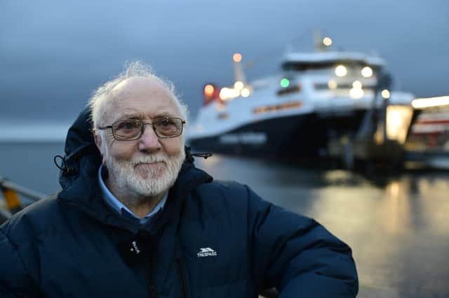 Arran Ferry Committee secretary Bill Calderwood beside Glen Sannox in Brodick