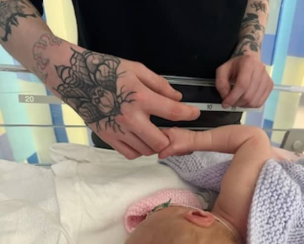 Baby Talia and father Euan. Anna Jackson, 22, started getting a pain in her abdomen, but had put it down to period cramps.  Picture: Anna Jackson/SWNS