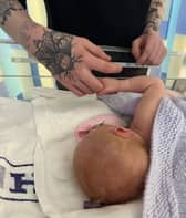 Baby Talia and father Euan. Anna Jackson, 22, started getting a pain in her abdomen, but had put it down to period cramps.  Picture: Anna Jackson/SWNS