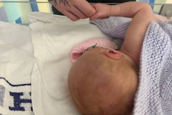 Baby Talia and father Euan. Anna Jackson, 22, started getting a pain in her abdomen, but had put it down to period cramps.  Picture: Anna Jackson/SWNS