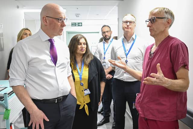 John Swinney, seen visiting Forth Valley Hospital, has said he is giving 'very personal leadership' to the NHS (Picture:  Lesley Martin)