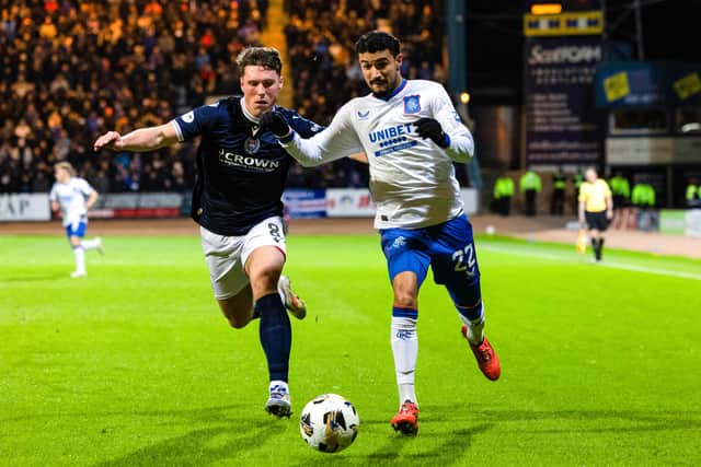 Dundee’s Josh Mulligan (left) challenges Rangers’ Jefte during a recent meeting between the clubs.