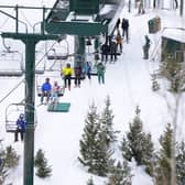Bar up or bar down? Skiers ride a chairlift at Deer Valley Ski Resort in Park City, Utah, December 2022