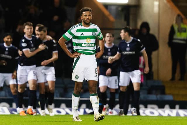Celtic's Auston Trusty looks dejected as Dundee players celebrate a goal. (Photo by Craig Foy / SNS Group)