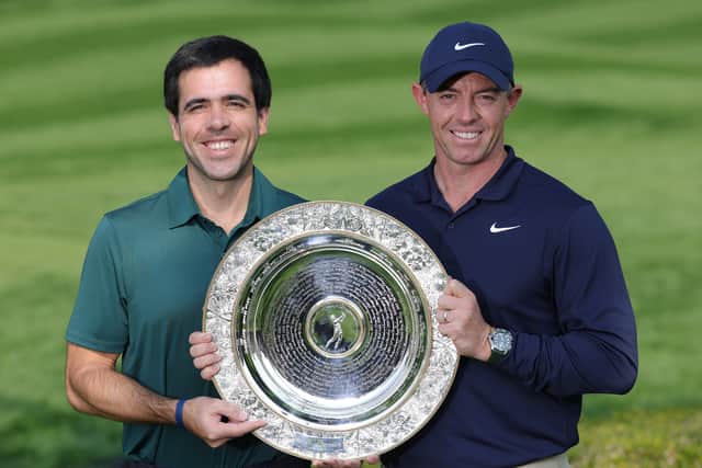 Rory McIlroy shows off the Seve Ballesteros Award for the 2024 DP World Tour Players' Player of the Year after being presented it by Javier Ballesteros, Seve’s son, prior to the Hero Dubai Desert Classic at Emirates Golf Club