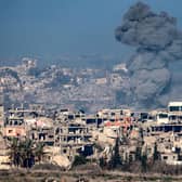 An image taken from the Israeli side of the border with the Gaza Strip shows a smoke plume rising from explosions above destroyed buildings in the northern Gaza Strip. Picture: Menahem Kahana/AFP via Getty Images