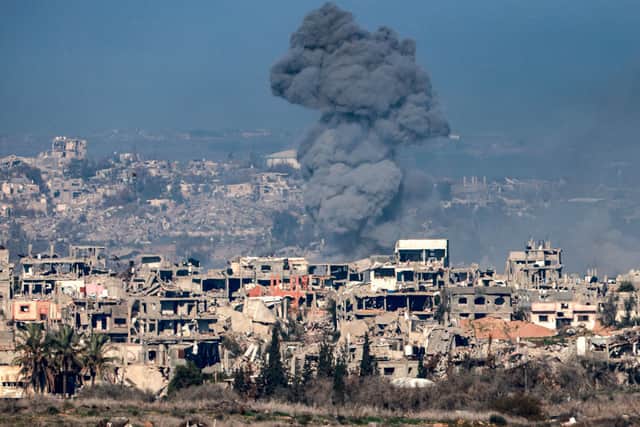 An image taken from the Israeli side of the border with the Gaza Strip shows a smoke plume rising from explosions above destroyed buildings in the northern Gaza Strip. Picture: Menahem Kahana/AFP via Getty Images