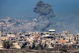An image taken from the Israeli side of the border with the Gaza Strip shows a smoke plume rising from explosions above destroyed buildings in the northern Gaza Strip. Picture: Menahem Kahana/AFP via Getty Images