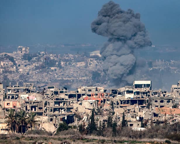 An image taken from the Israeli side of the border with the Gaza Strip shows a smoke plume rising from explosions above destroyed buildings in the northern Gaza Strip. Picture: Menahem Kahana/AFP via Getty Images