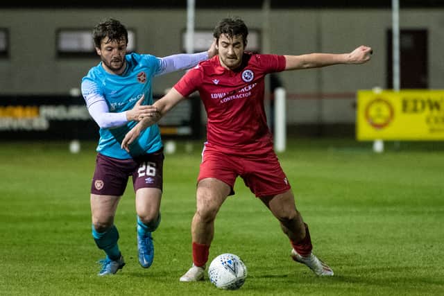 Hearts Craig Halkett (L) in action with Jordan MacRae of Brora in 2021.