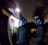 Police used a chainsaw to raid a drug house where they arrested a 13-year-old boy on suspicion of having a zombie knife. 