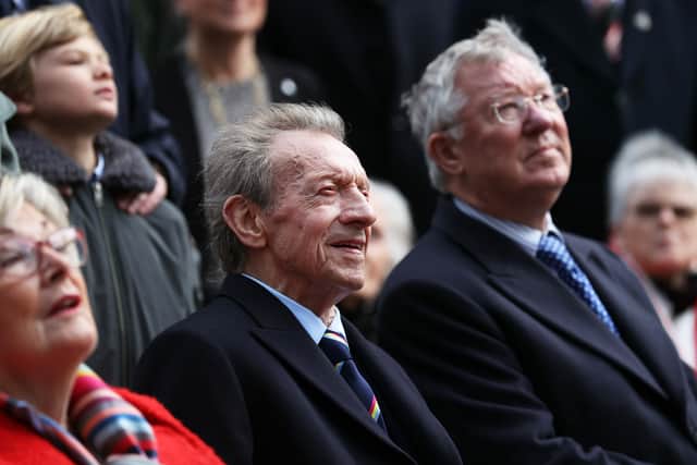 Denis Law sits alongside Sir Alex Ferguson in 2021.