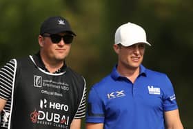 Calum Hill chats to caddie Mike Thomson during the third round of the Hero Dubai Desert Classic at Emirates Golf Club