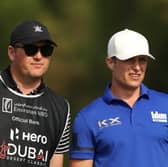 Calum Hill chats to caddie Mike Thomson during the third round of the Hero Dubai Desert Classic at Emirates Golf Club