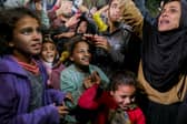 People celebrate along a street at Deir el-Balah in the central Gaza Strip,as news spread that a ceasefire and hostage release deal had been reached between Israel and Hamas.