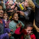 People celebrate along a street at Deir el-Balah in the central Gaza Strip,as news spread that a ceasefire and hostage release deal had been reached between Israel and Hamas.