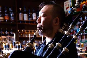Tomohiro Onuki playing the bagpipes in his Royal Scotsman pub in Tokyo.
