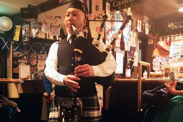Tomohiro Onuki playing the bagpipes in his Royal Scotsman pub in Tokyo.