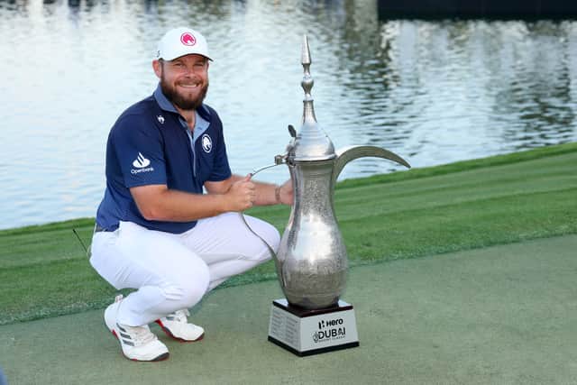 Tyrrell Hatton poses with the iconic Dallah Trophy after his victory in the Hero Dubai Desert Classic at Emirates Golf Club