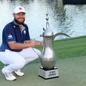 Tyrrell Hatton poses with the iconic Dallah Trophy after his victory in the Hero Dubai Desert Classic at Emirates Golf Club