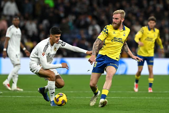 Las Palmas substitute Oli McBurnie is challenged by Real Madrid's Chema Andres during the La Liga match at the Bernabeu. (Photo by Denis Doyle/Getty Images)