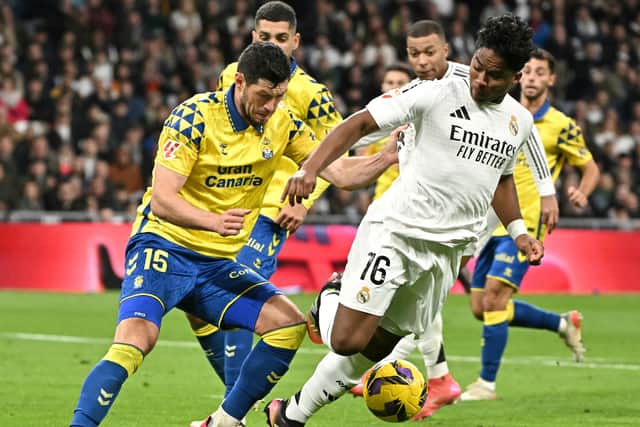 Las Palmas defender Scott McKenna keeps a close eye on Real Madrid striker Endrick during the La Liga clash at the Santiago Bernabeu. (Photo by JAVIER SORIANO/AFP via Getty Images)