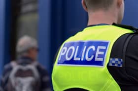A forensic tent has been erected, with ambulances and police vehicles in attendance