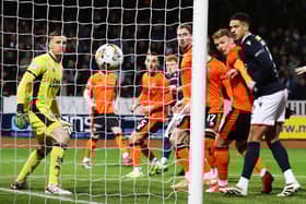 Dundee striker Simon Murray scores with a first-minute header against Dundee United in the Scottish Cup fourth round.  (Photo by Craig Williamson / SNS Group)