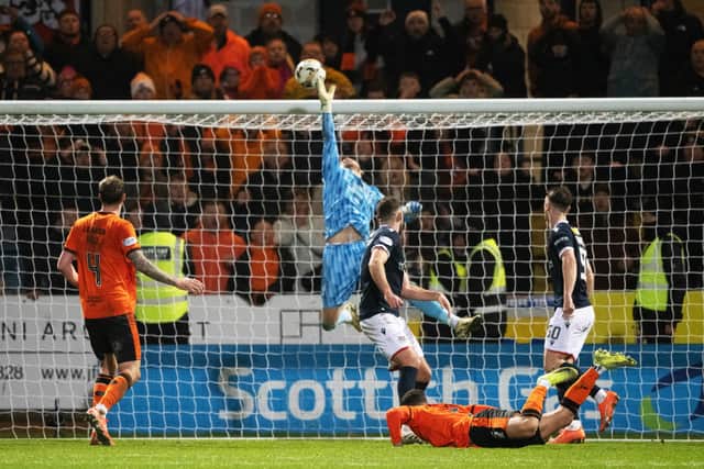 Dundee's Trevor Carson tips over from Vicko Sevelj as Dundee United pile on the pressure. (Photo by Paul Devlin / SNS Group)