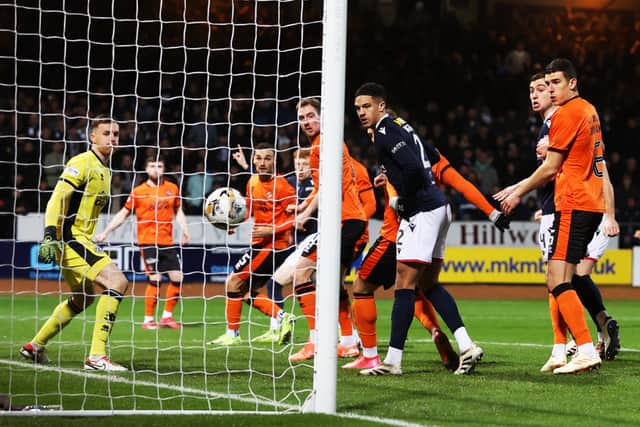Simon Murray glances the ball home for the only goal of the match at Dens Park.