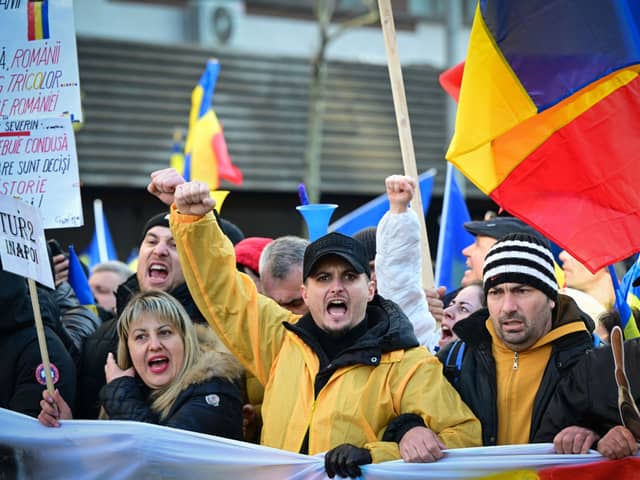 Supporters of Romanian nationalist party AUR and presidential candidate Calin Georgescu attend a march in Bucharest to protest against the annulment of the presidential election. (Picture: Daniel Mihailescu) 