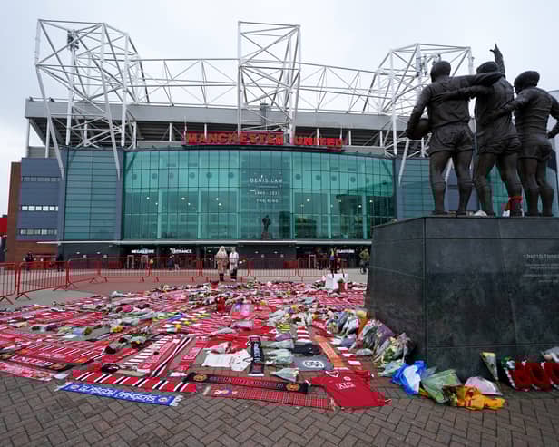 Tributes in memory of Denis Law, at the foot of the United Trinity Statue,  outside Old Trafford, home of Manchester United. Picture date: Wednesday January 22, 2025.