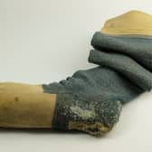 A blue woollen knitted sock owned by Robert Burns, complete with the initials "RB", is among the most popular of artefacts linked to the poet. The size eight socks date to around 1770-1796.