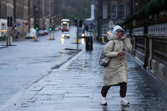 A woman shields herself from the wind during Storm Eowyn on Princes Street, Edinburgh. Schools have been closed and people warned not to travel on Friday, as 100mph winds pose a danger to life in parts of the UK as Storm Eowyn hits the country. Pic Jane Barlow/PA Wire.