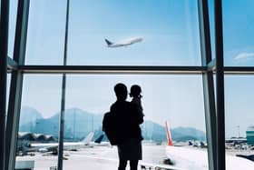 Man and boy looking at plane taking off