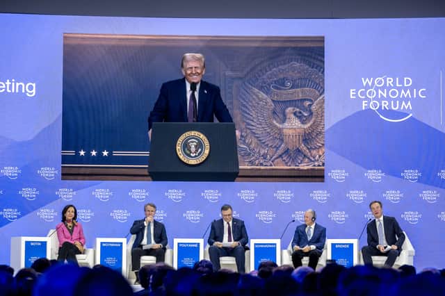 US President Donald Trump is seen on a giant screen during his address by video conference at the World Economic Forum annual meeting in Davos, Switzerland