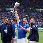 Tommaso Menencello of Italy celebrates with the Cuttitta Cup following the team's victory during the Guinness Six Nations 2024 match between Italy and Scotland at Stadio Olimpico.