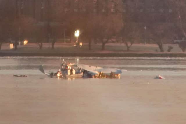 Emergency response units search the crash site of the American Airlines plane on the Potomac River after the plane crashed on approach to Reagan National Airport.