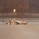 Emergency response units search the crash site of the American Airlines plane on the Potomac River after the plane crashed on approach to Reagan National Airport.